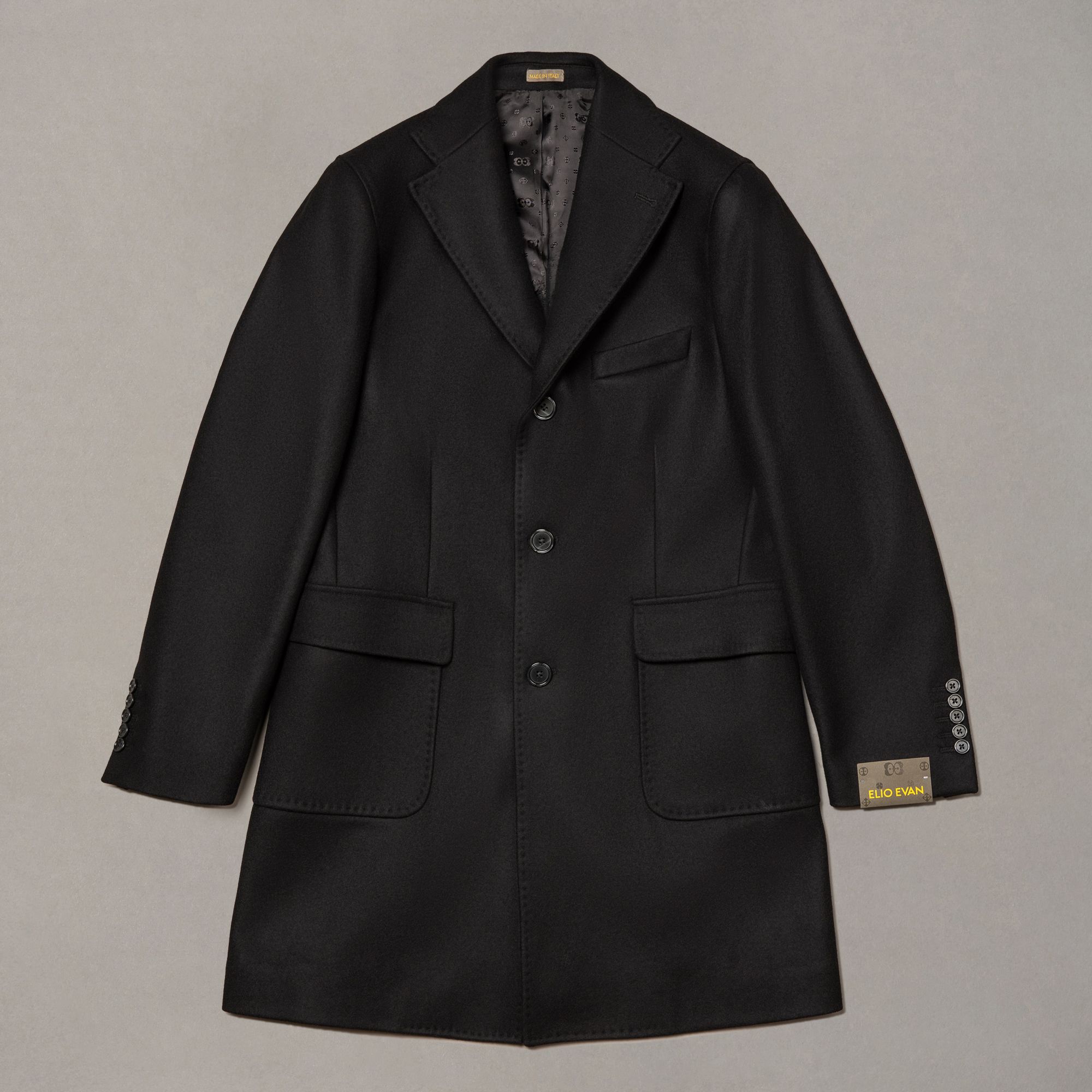 Black wool-nylon coat by Elio Evan — single-breasted front and natural shoulder