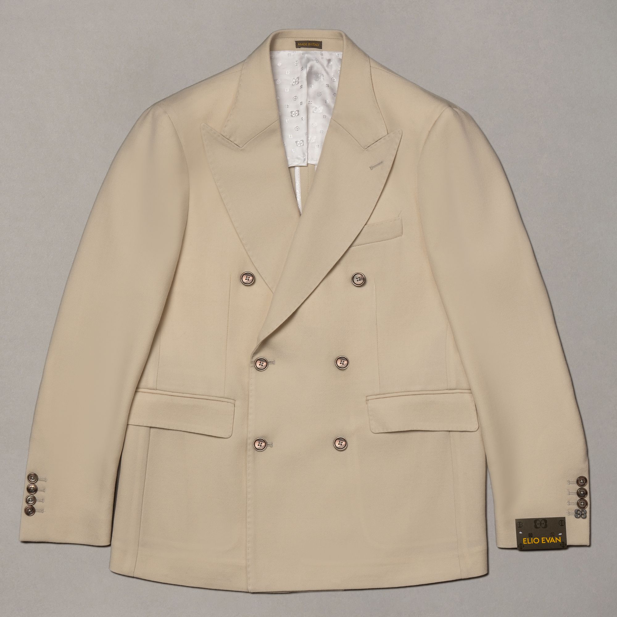 White wool jacket by Elio Evan — double-breasted with a shaped waist and natural shoulder