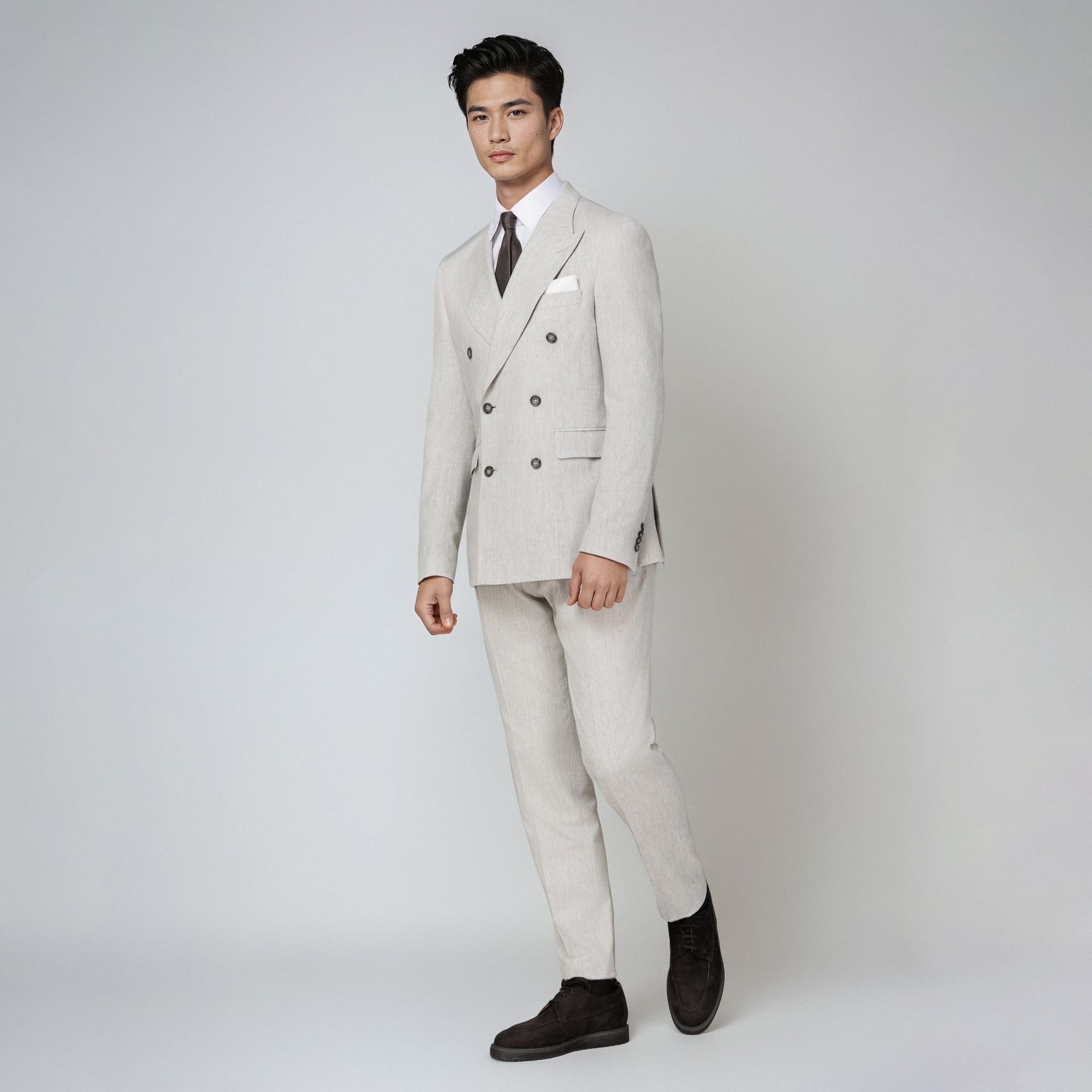 Men’s total look with off-white double-breasted suit and brown loafers by Elio Evan