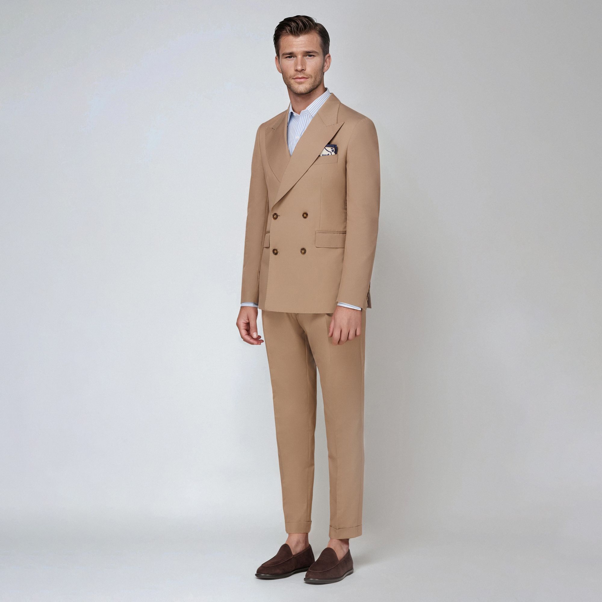 Tan men’s double-breasted suit by Elio Evan in wool cotton gabardine with pleated trousers. Made in Italy.