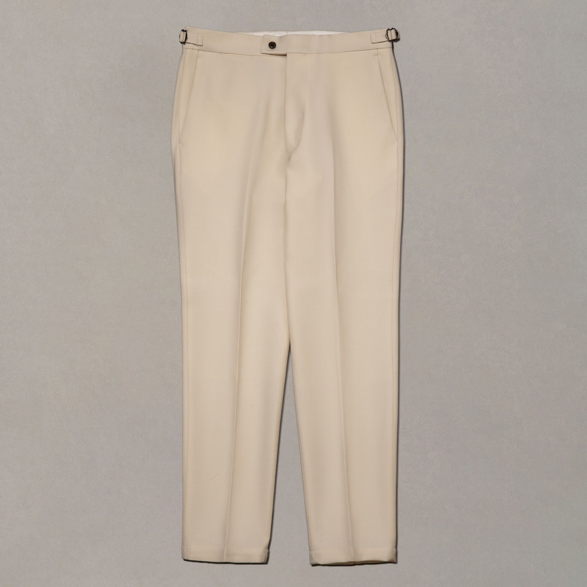 White wool trousers by Elio Evan — plain fabric with a clean, uninterrupted leg line