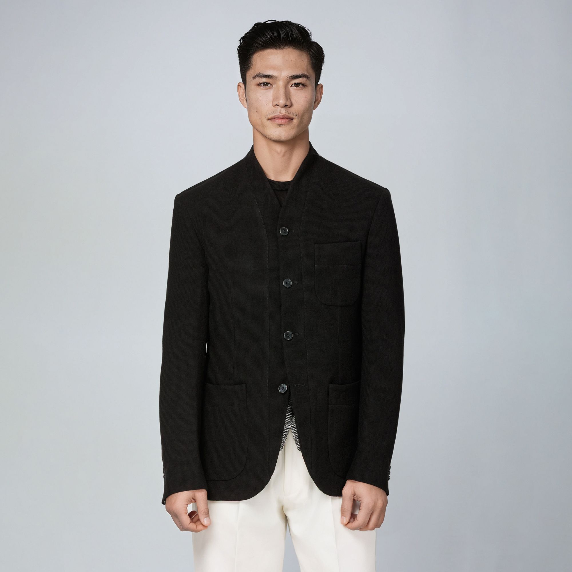 Deconstructed men’s jacket in knitted virgin wool canvas with stand-up collar and patch pockets.