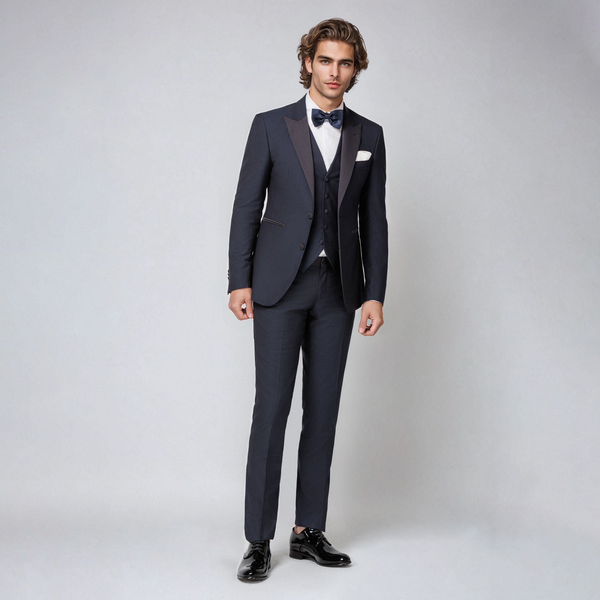 Navy three-piece tuxedo by Elio Evan in houndstooth jacquard with satin lapels and buttons. Bristol fit. Made in Italy.