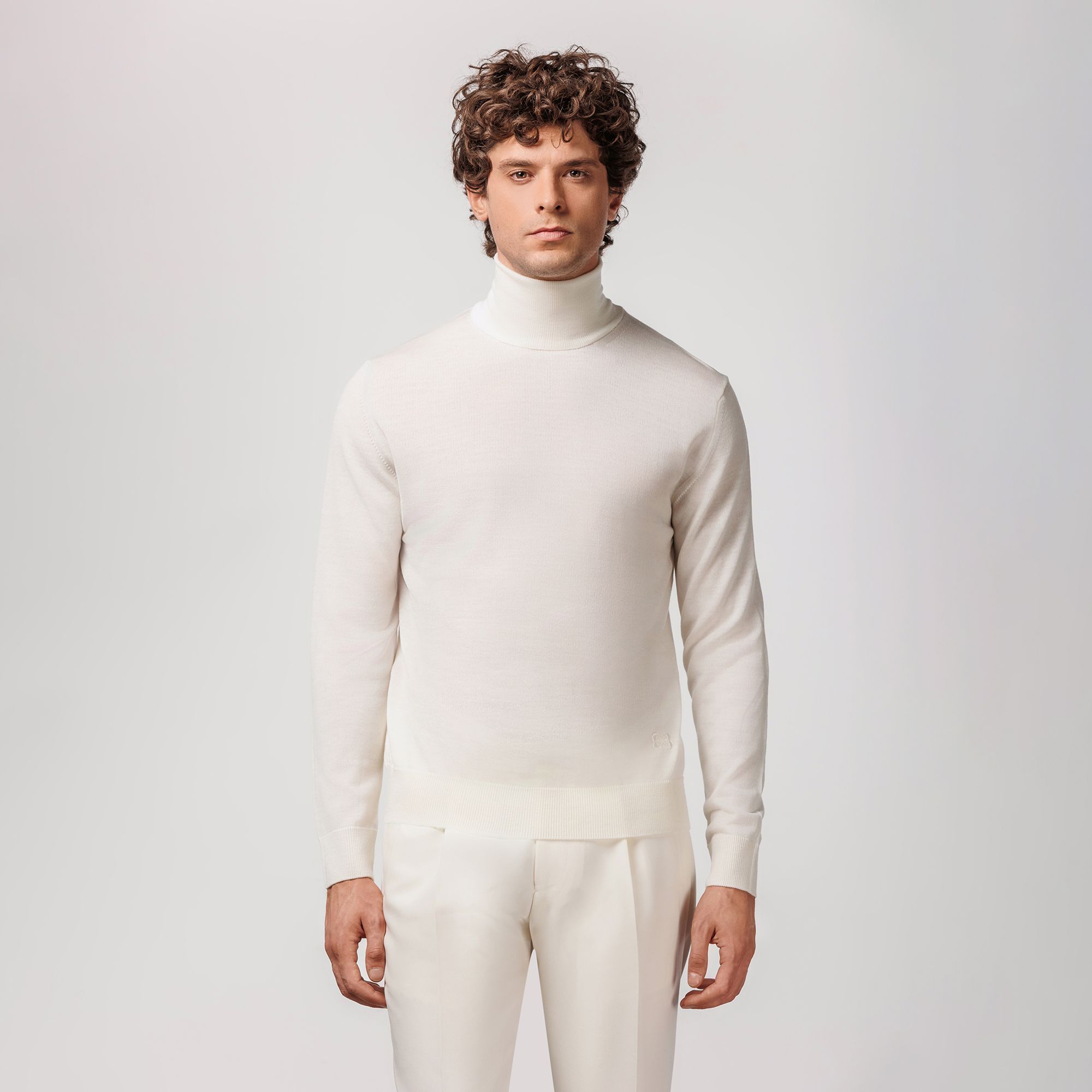 White rollneck sweater by Elio Evan, crafted from extrafine merino wool with ribbed hems and flawless fit.